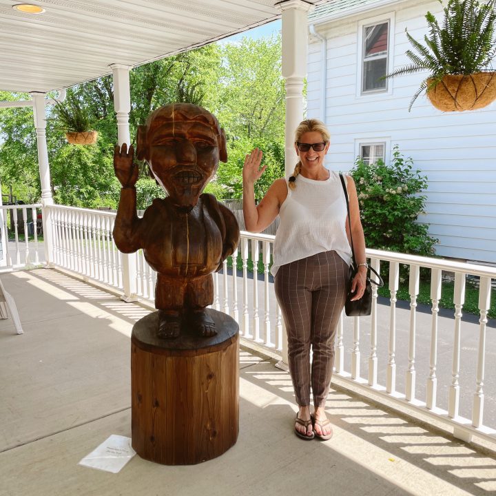 Carrie Green-Zinn standing next to a large troll in Mt. Horeb, WI.