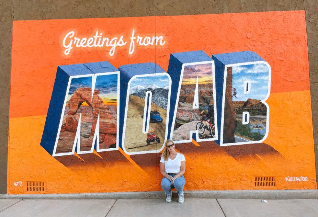 Carrie Green-Zinn in front of the Moab sign.