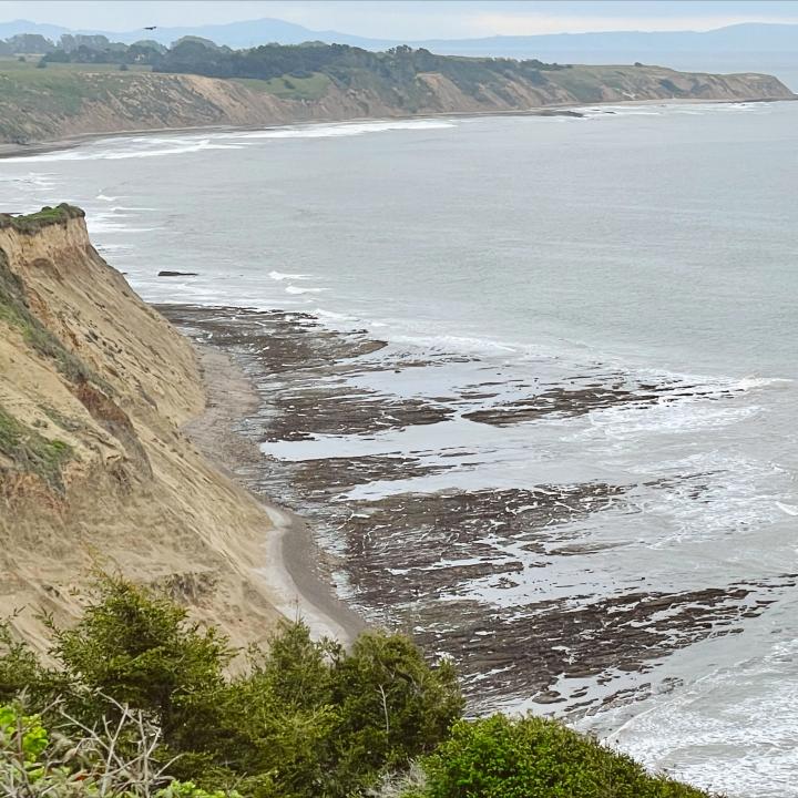 Breathtaking aerial view of Alamere Falls, showcasing the cascading waterfall and rugged terrain, perfect for Bay Area hiking enthusiasts