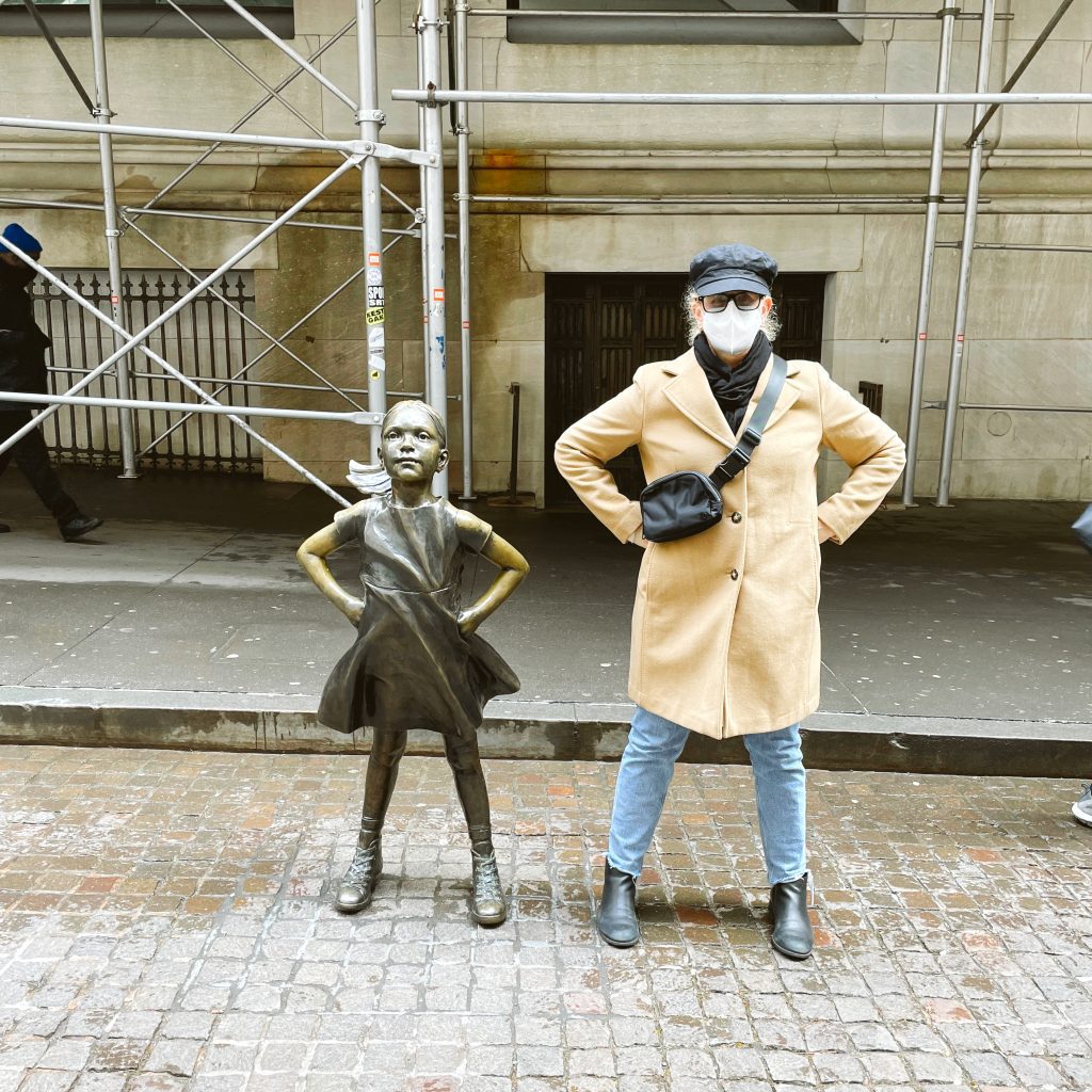 Carrie Green-Zinn next to the Fearless Girl at the New York Stock Exchange