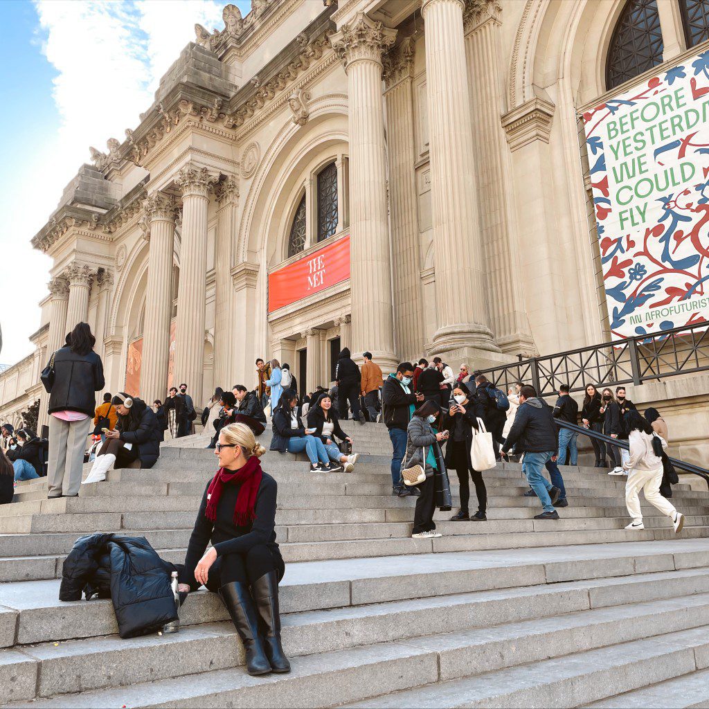 Carrie Green-Zinn sitting on the steps of The Met in New York City