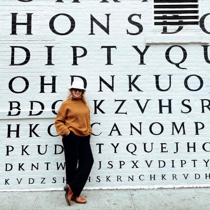 Carrie Green Zinn  in front of DIPTYQ wall in SoHo on a 3 days in NYC Itinerary