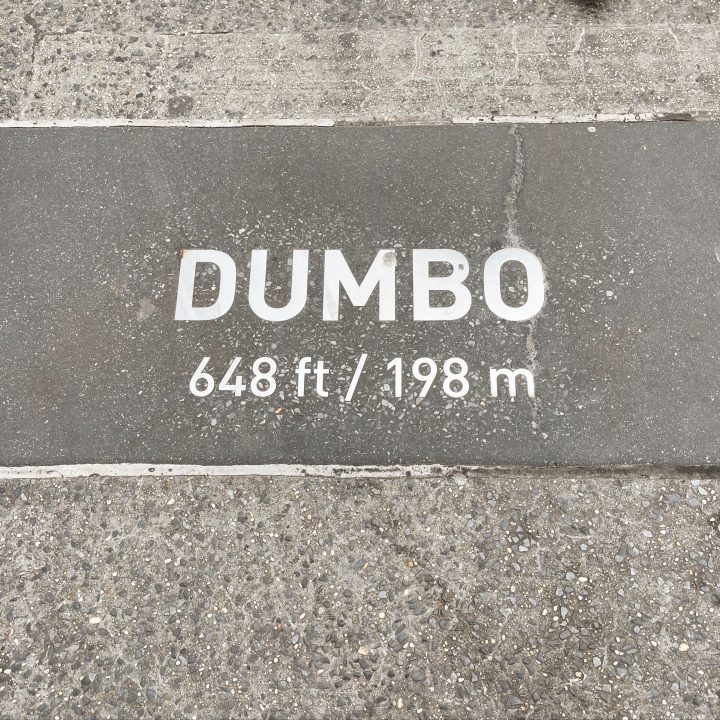 The DUMBO sign in the pavement off the Brooklyn Bridge