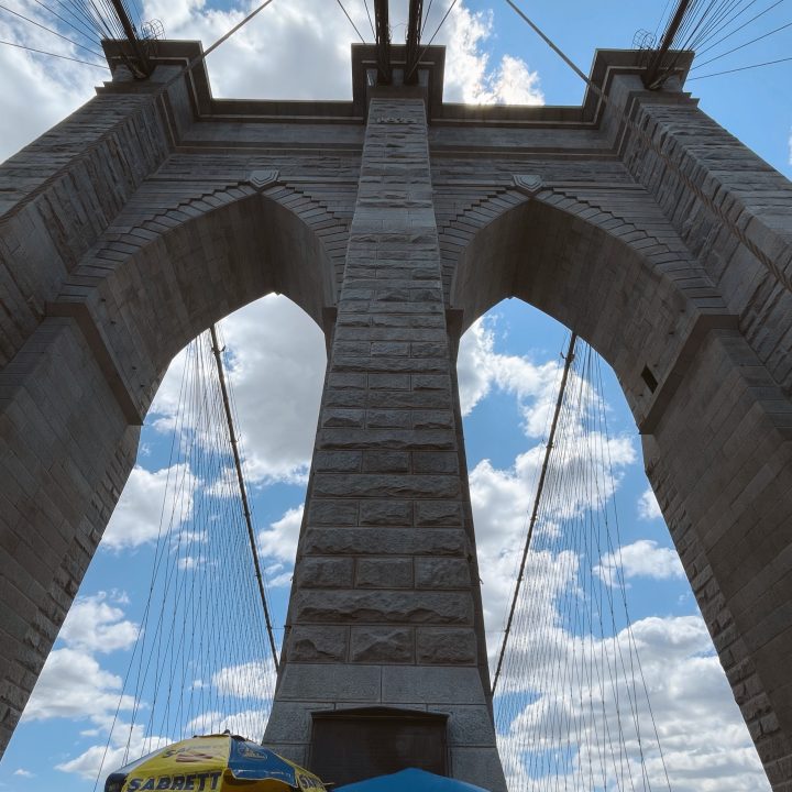 The towers of the Brooklyn Bridge up close while walking across.