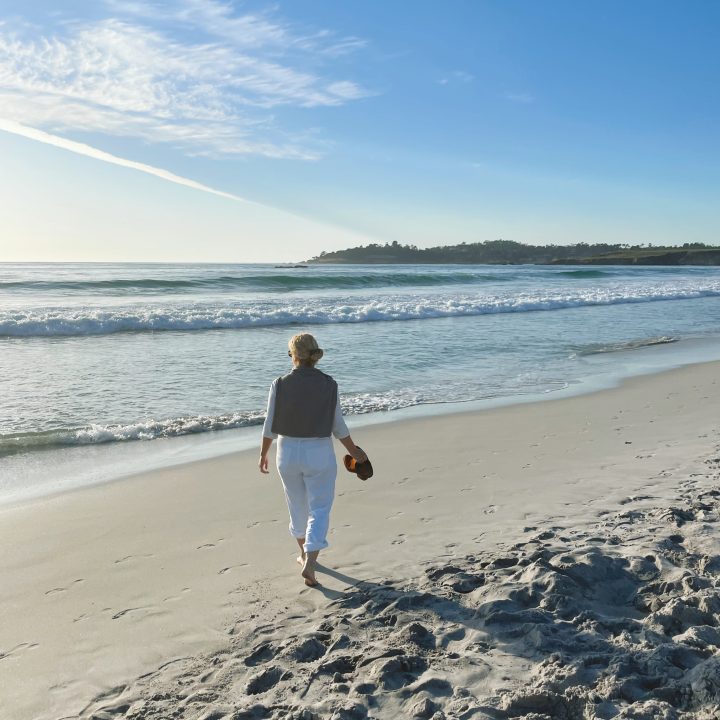 Carrie walking on the Carmel Beach while staying at a Carmel Hotel with Ocean View