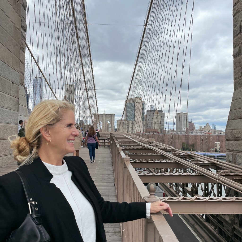 Carrie Green Zinn looking at the view while walking the Brooklyn Bridge