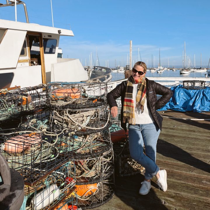 Carrie Green Zinn standing by the boats at Old Fisherman's Wharf