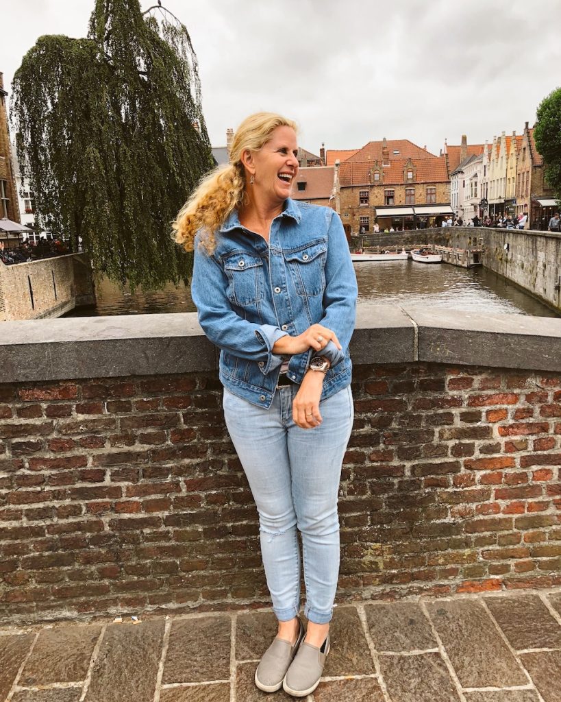 Carrie Green-Zinn at a canal in Bruges, Belgium which is one of the hidden gems of Europe