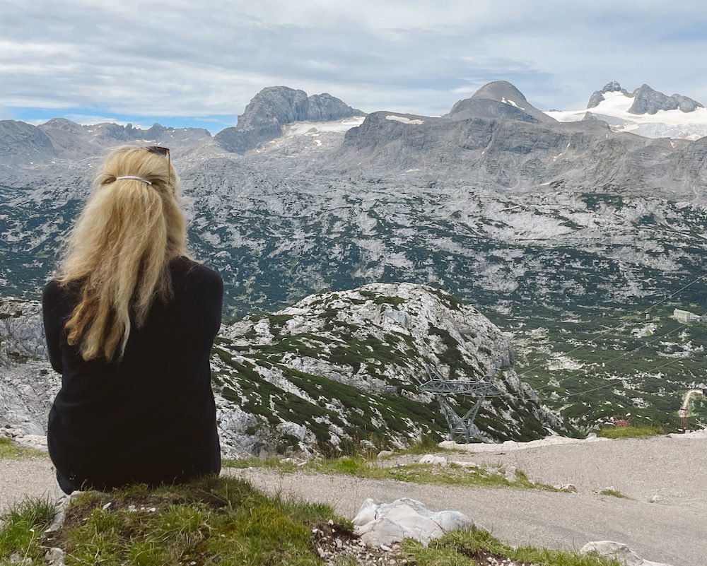 Carrie Green-Zinn overlooking the Dachstein Glacier above Hallstatt Austria which is a hidden gem of Europe
