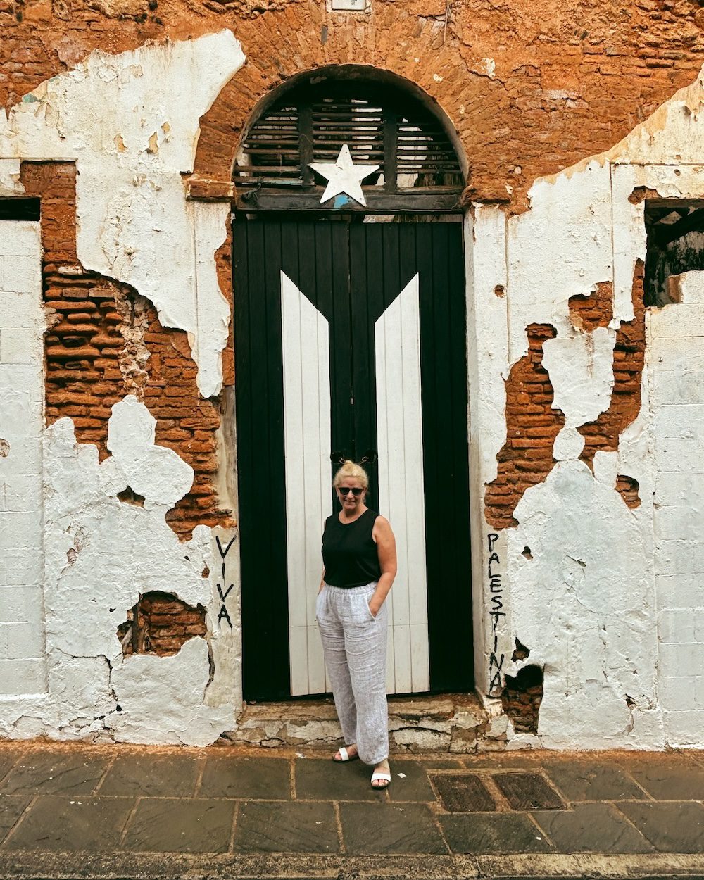 Carrie Green-Zinn in front of the Puerto Rican flag door in Old San Juan