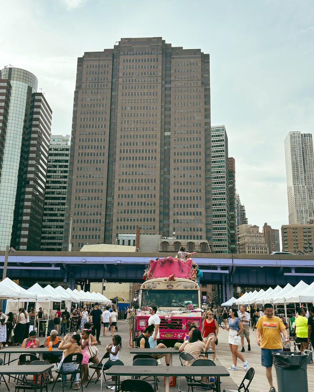 A Saturday at South Street Seaport with a view of the public market and Manhattan skyscrapers in the background.