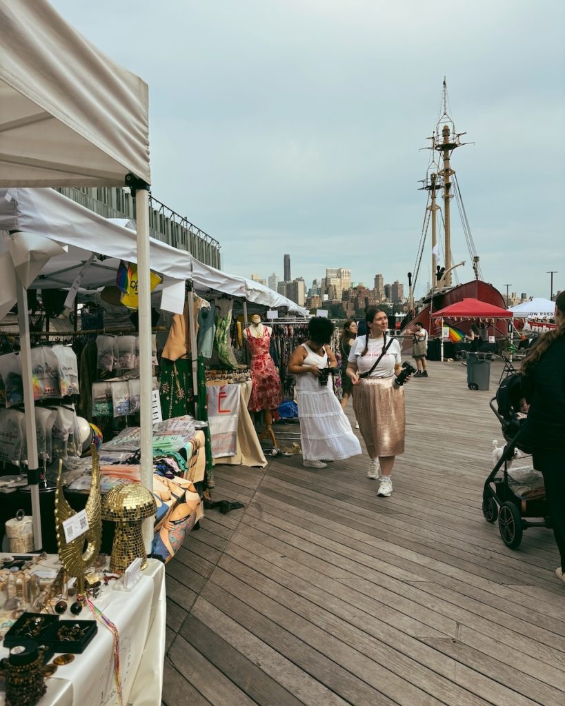 The Public Market with booths and people shopping on a Saturday at South Street Seaport.
