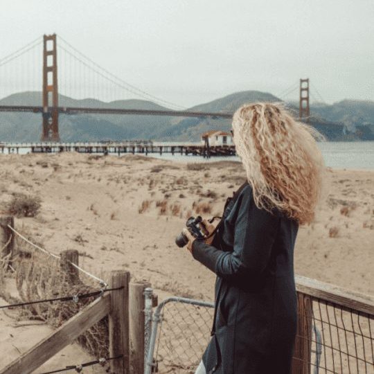 Woman looking at Golden Gate Bridge in the distance