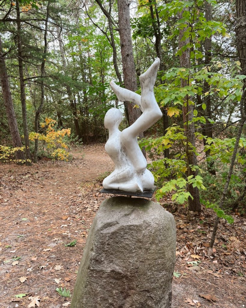 A white sculpture in the forest Art Walk of Elk Rapids, Michigan