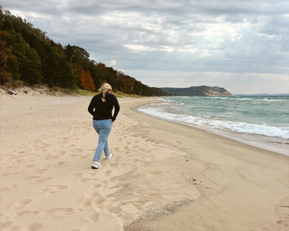 Carrie Green-Zinn walking on the beach in Elk Rapids, Michigan
