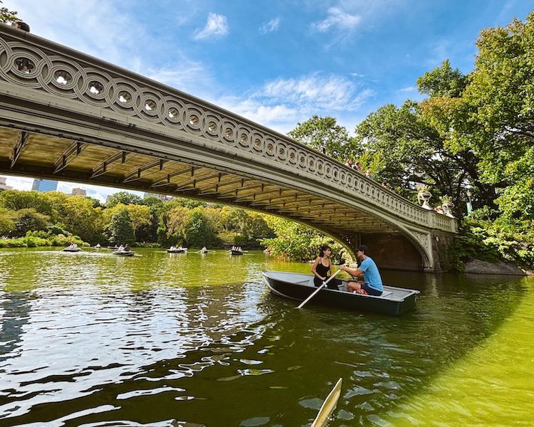 Row boat in Central Park under the long bridge.