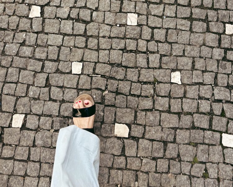 Carrie Green-Zinn in a Munro sandal walking in Europe.