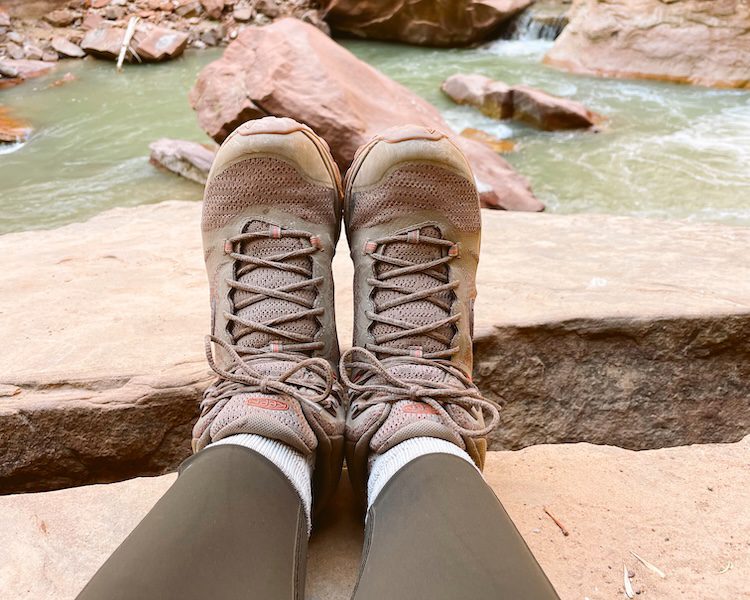 Carrie Green-Zinn's hiking boots resting on some rocks along the trail